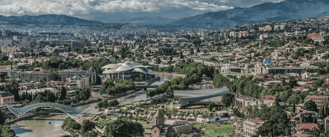 MBBS in Georgia banner showcasing affordable tuition, English-medium programs, and globally recognized degrees at MCI-approved universities. Features a cityscape of Tbilisi with a 'Talk to an Expert' call-to-action button.